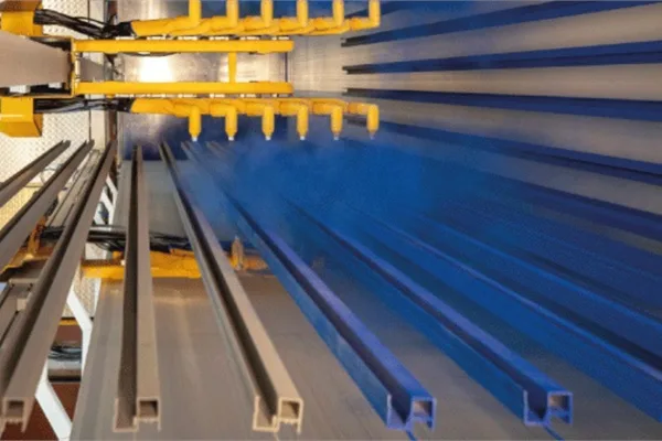 Automated powder coating spray booth applying architectural finish to pultruded FRP window profiles