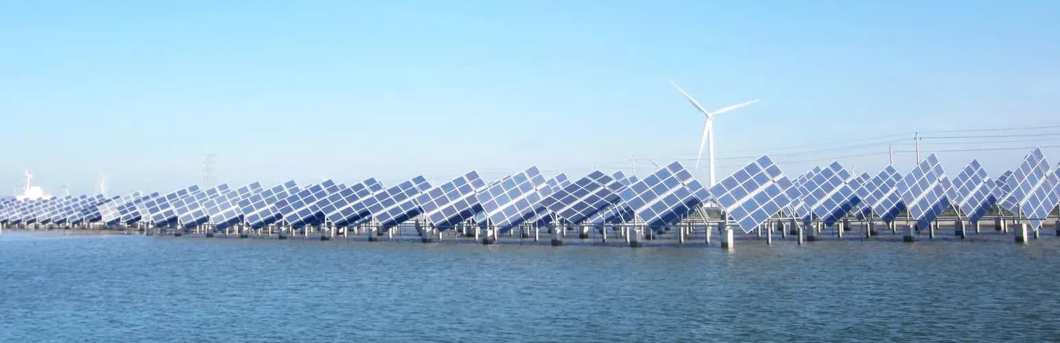Wind-solar-fishery hybrid plant with PV arrays over saline water and an offshore wind turbine in the distance, the operating environment for pultruded FRP solar mounts and module frames