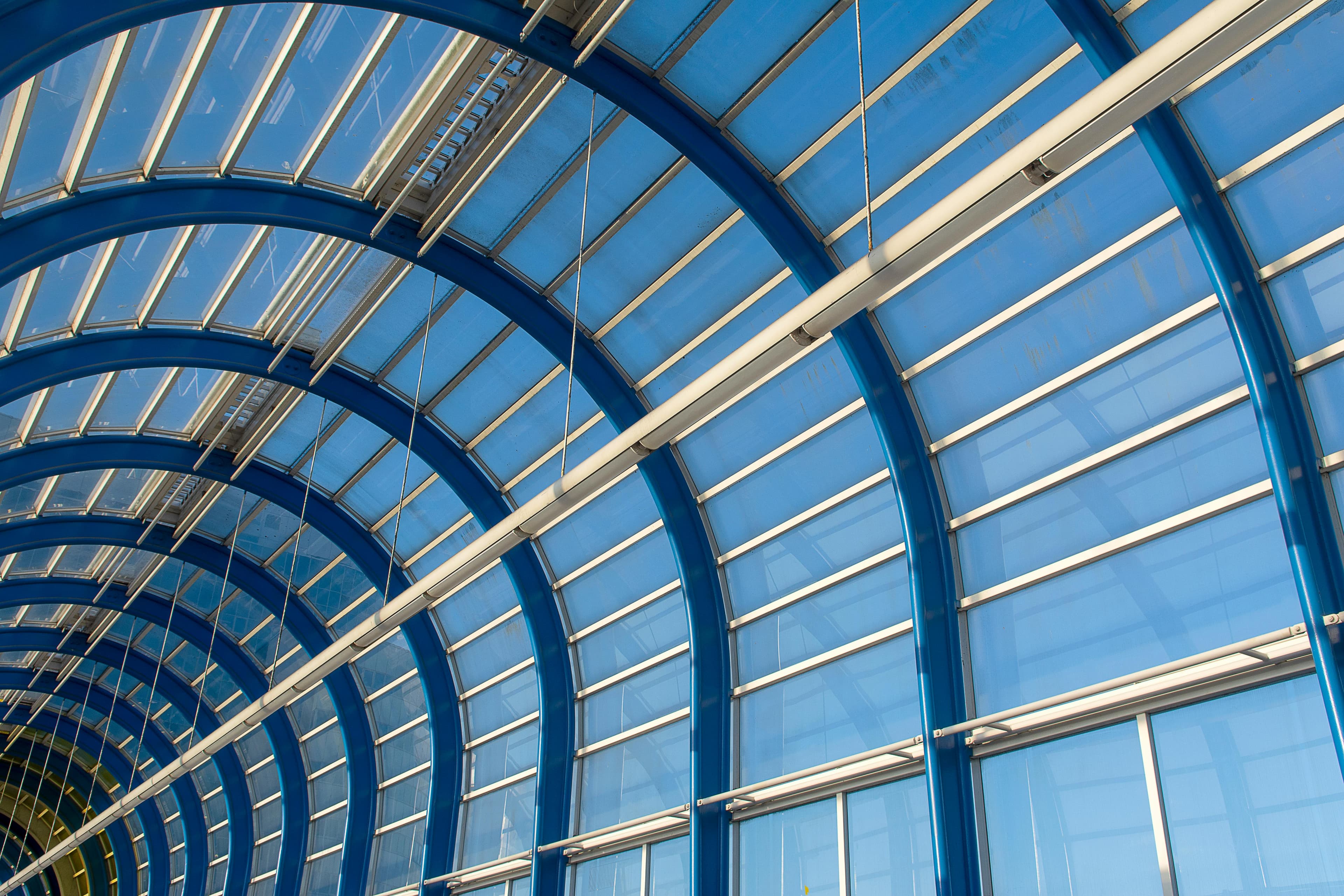 Modern architectural glazing structure with curved frame profiles and glass panels — representative of high-performance fenestration systems