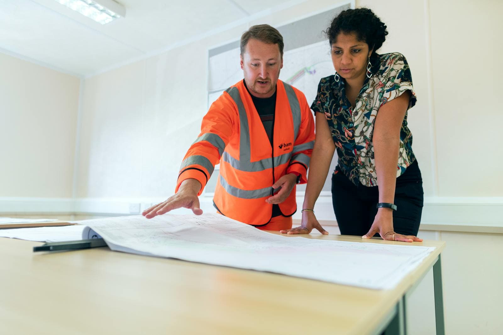 Engineers reviewing technical drawings as part of peer benchmarking and product strategy work
