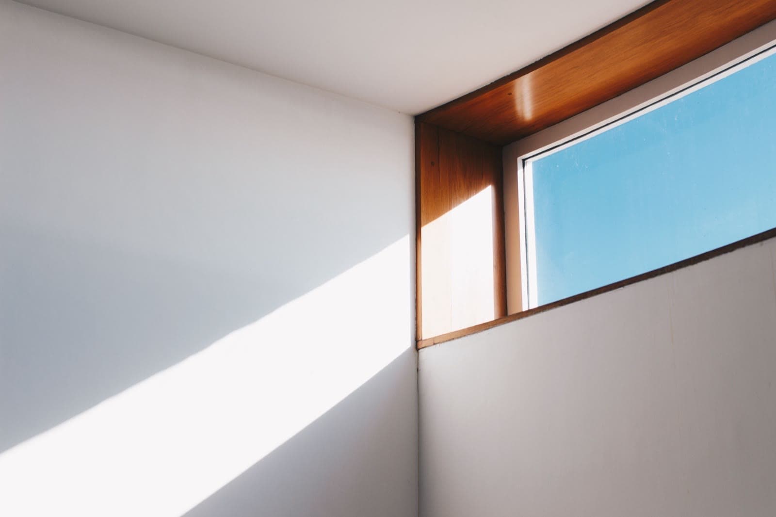 Interior view of a window corner joint — the frame-to-glass edge zone where the spacer thermal bridge Ψg concentrates whole-window heat loss