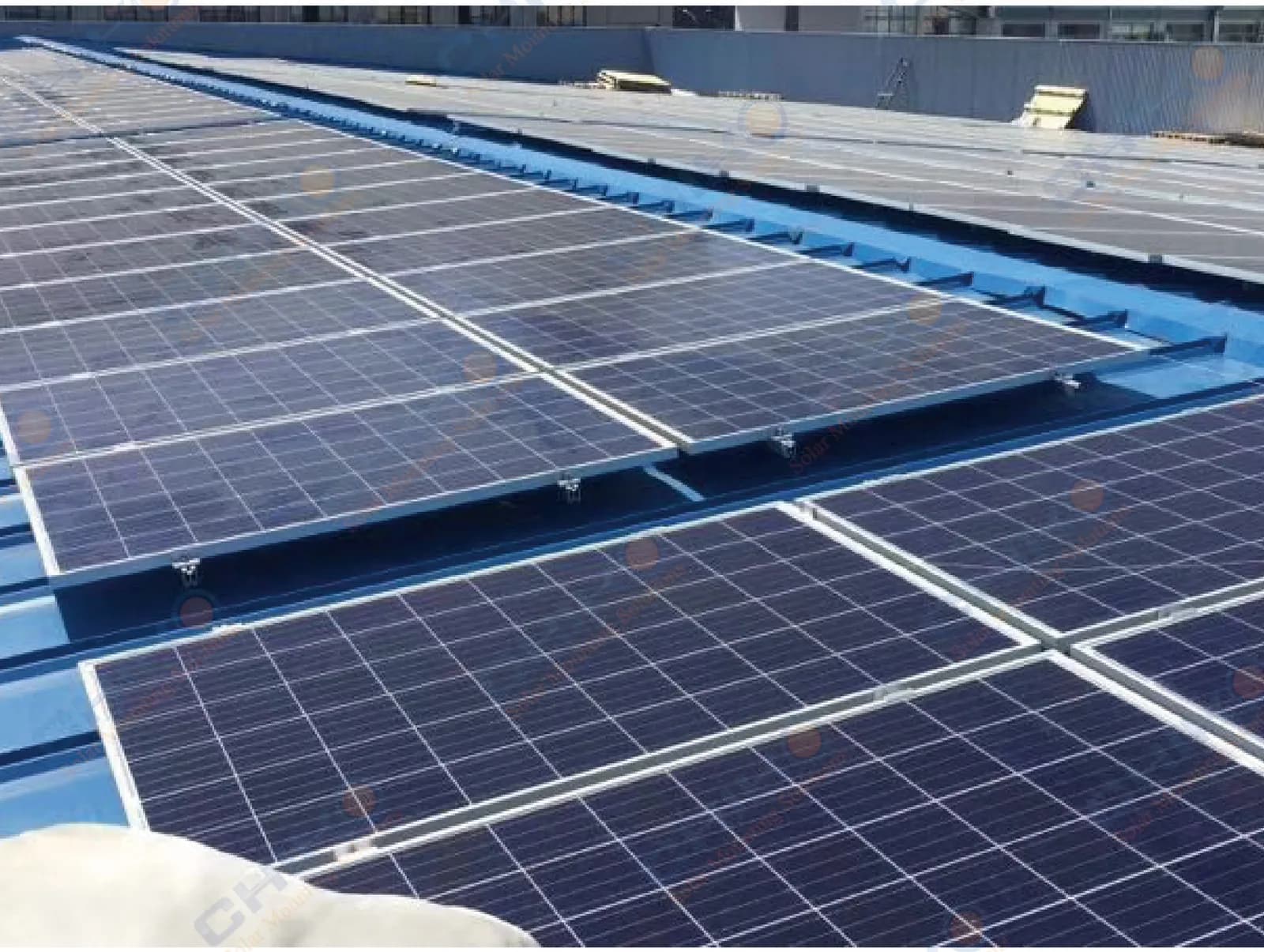 Pultruded FRP solar mounting profiles supporting photovoltaic modules on an industrial rooftop