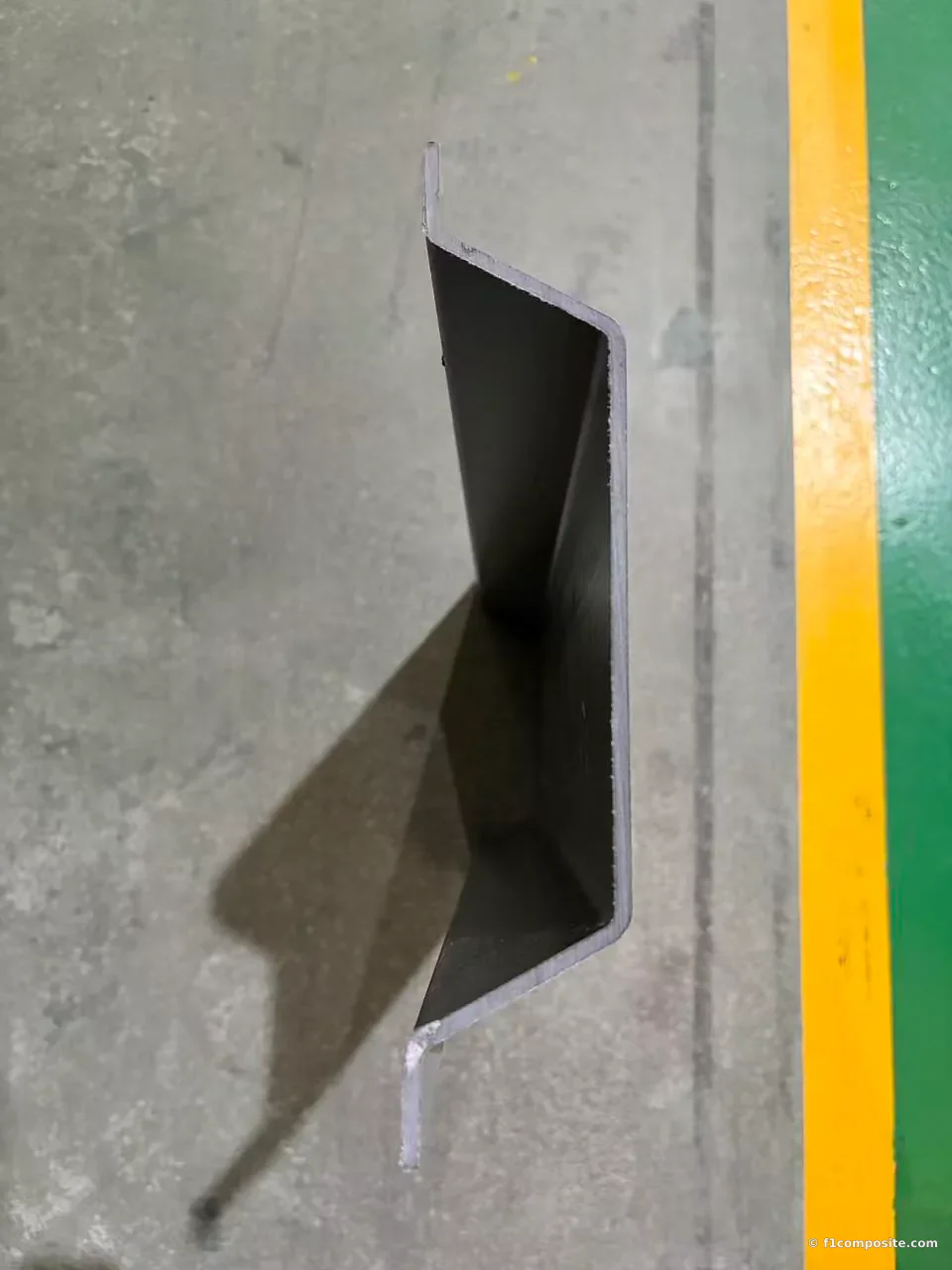 Black pultruded FRP sheet-program sample with thin walls and formed return edges