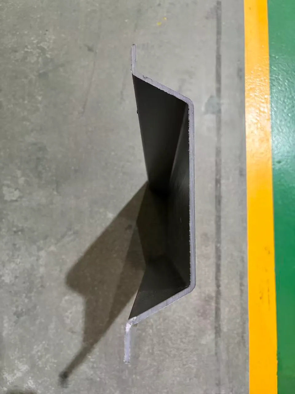 Black pultruded FRP sheet-program sample with thin walls and formed return edges