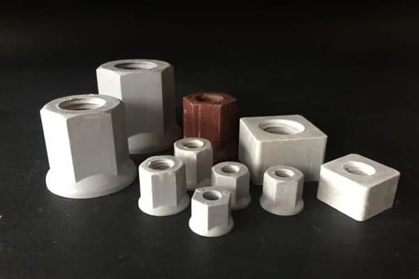 Composite hexagonal and square nuts showing different heights and bearing faces