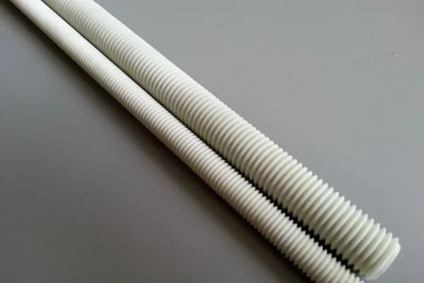 Two grey fiberglass vinyl ester threaded rods