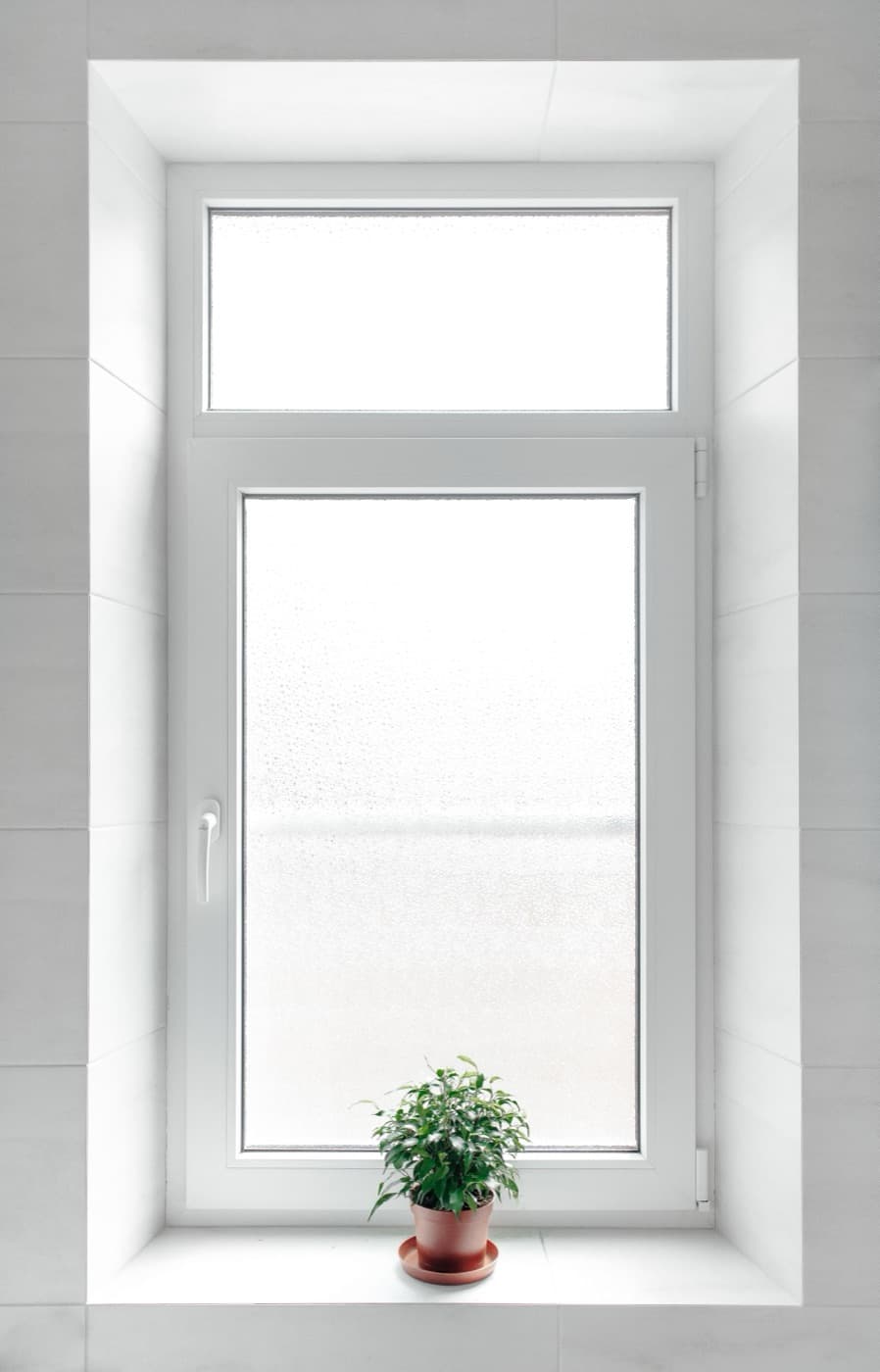 White uPVC tilt-and-turn window — the hollow reinforcement chamber inside frames like this is where pultruded fiberglass cores replace galvanized steel inserts