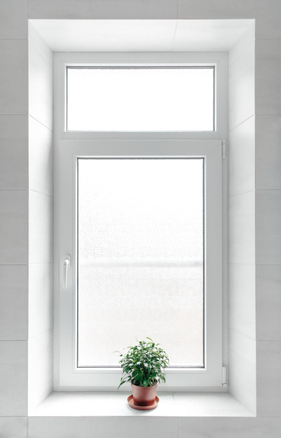 White uPVC tilt-and-turn window — the hollow reinforcement chamber inside frames like this is where pultruded fiberglass cores replace galvanized steel inserts