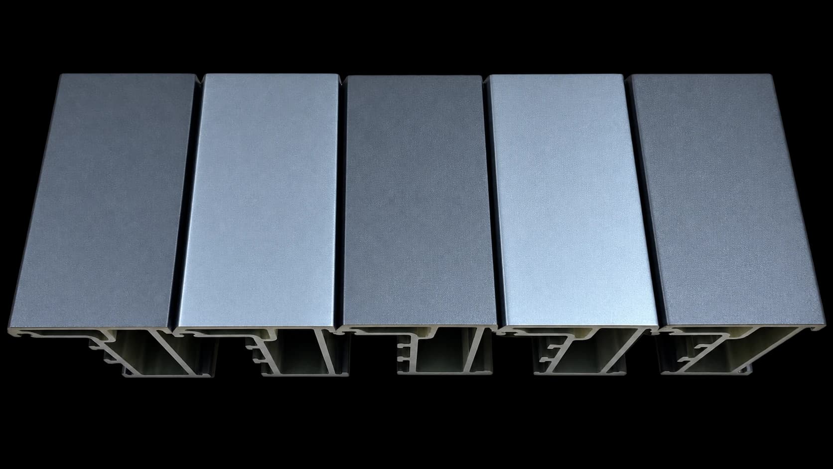 Five dark gray FRP window and door profile samples showing their cross-sections