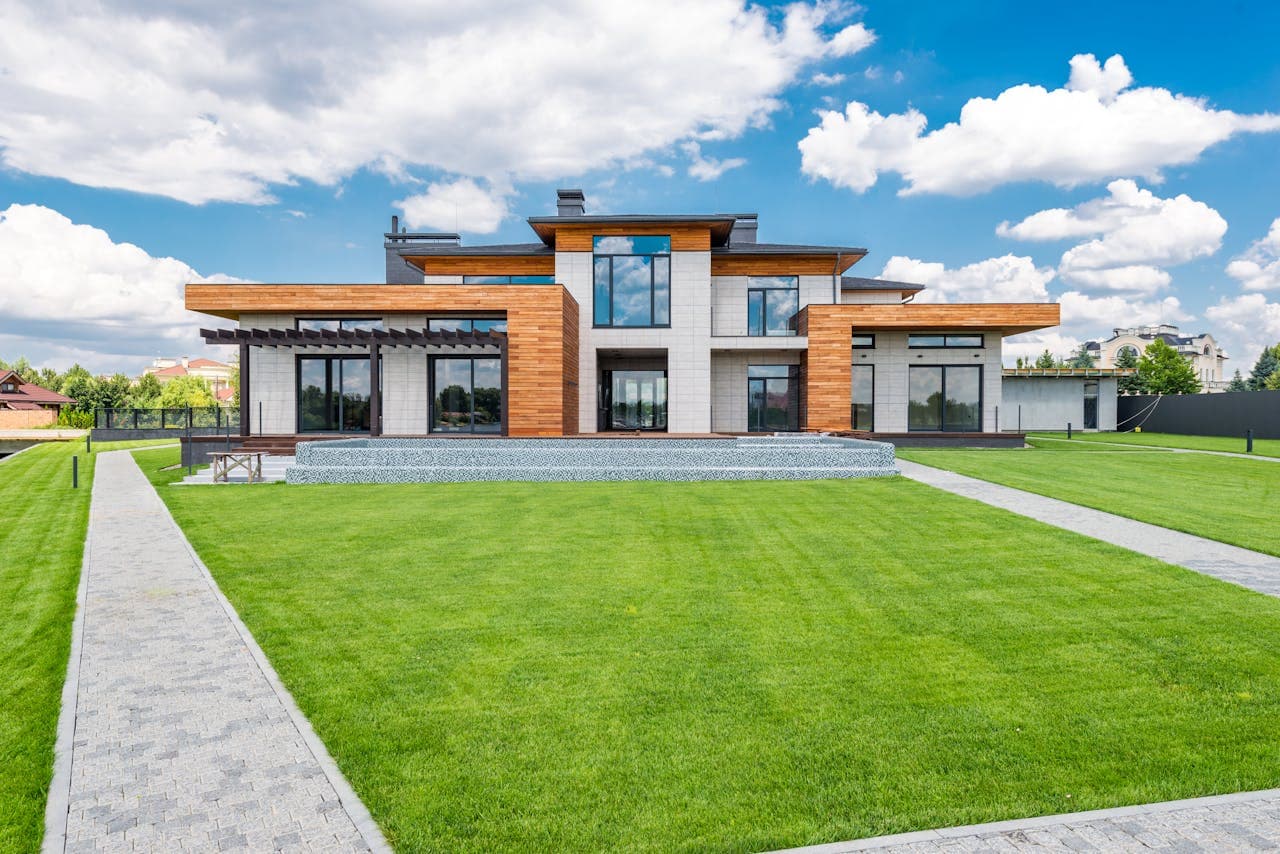 Passive house facade with large triple-glazed openings — pultruded FRP (GFK) window frames hold certified Passivhaus U-values without a metallic thermal break