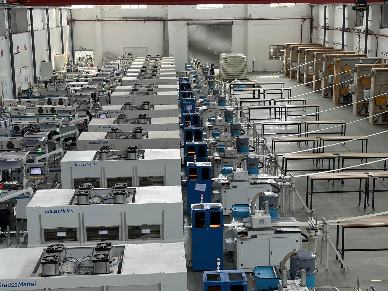 F1 Composite pultrusion hall — wide-angle view of multiple Krauss Maffei pultrusion lines running in parallel, with downstream cutting and handling tables