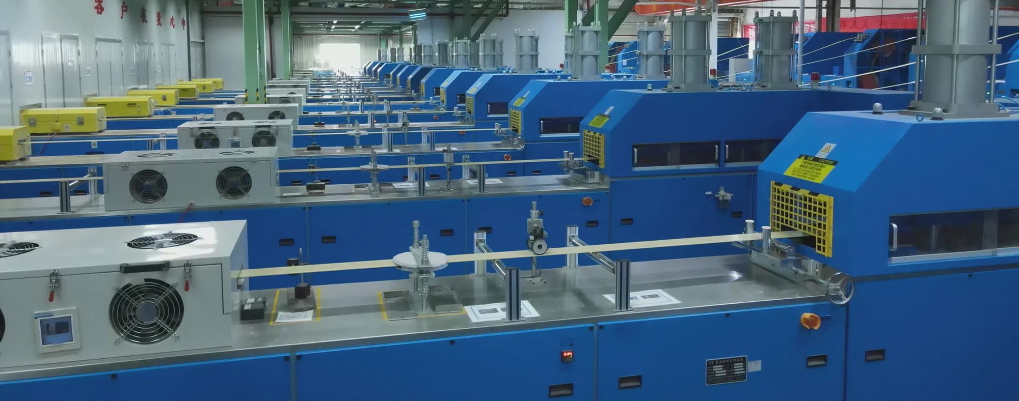 Fiberglass reinforced plastic production line pulling continuous glass fibers through heated pultrusion dies