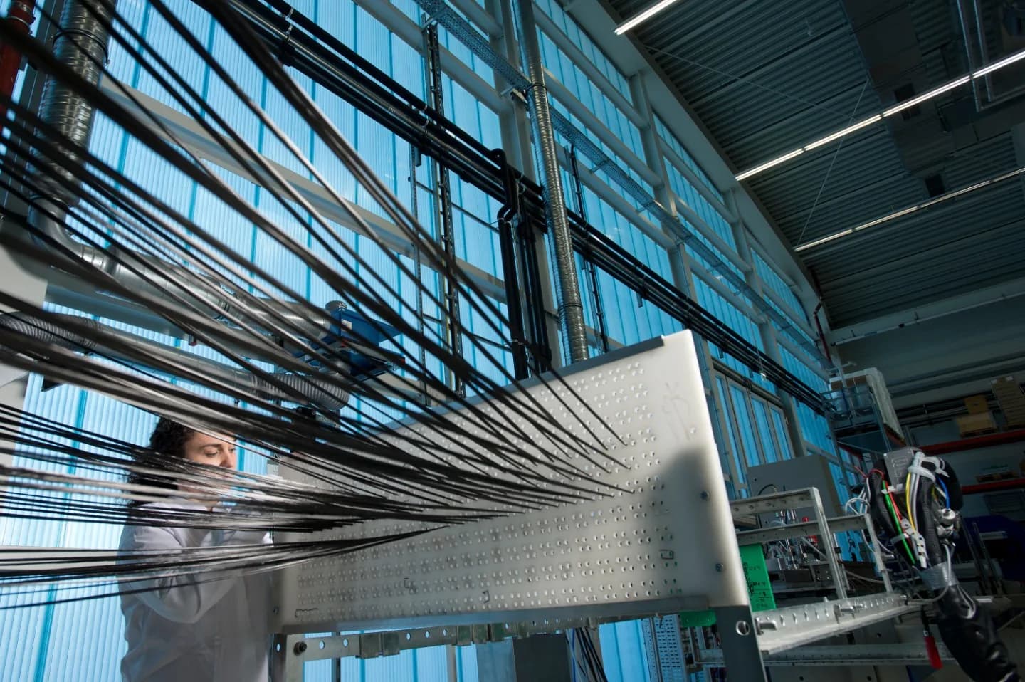 Pultrusion manufacturing line turning glass reinforcement and resin into continuous FRP profiles